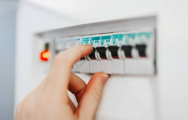 istock Male hand switching on fuse board. 1943005211