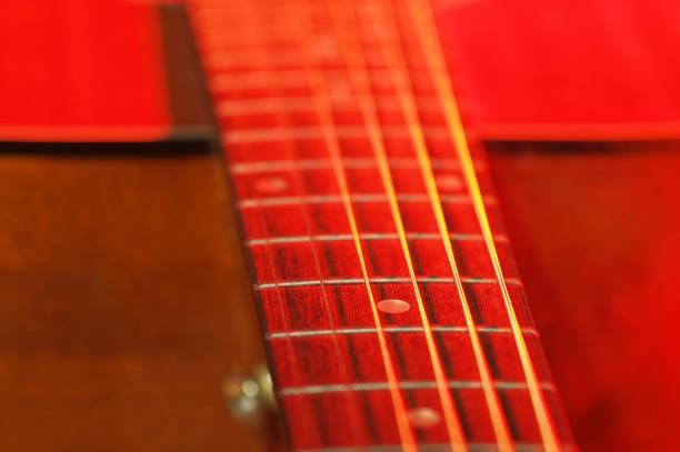 Red music background, guitar and strings in a minimalist approach.