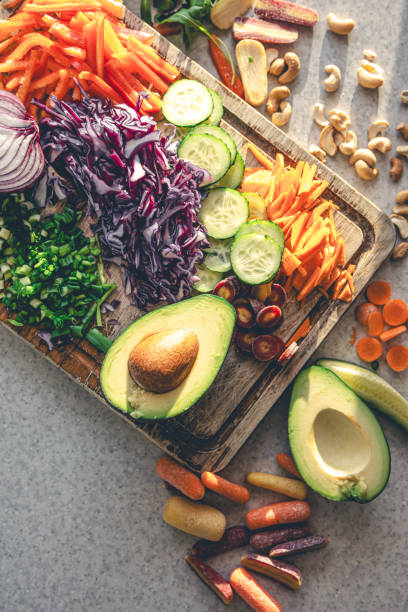 istock Sliced fresh vegetables on a cutting board on the kitchen table, top view. 1943024483