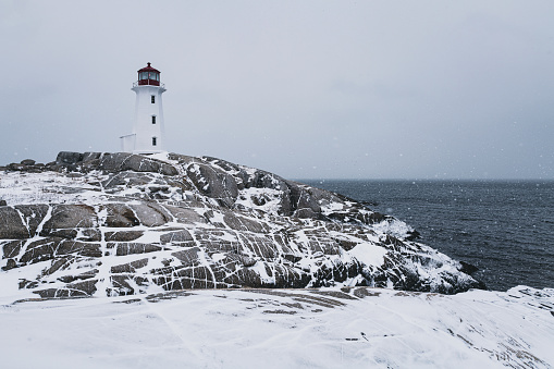 Heavy snow falls at Peggy's Cove Lighthouse.