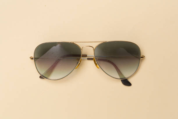 istock Sunglasses on color background, top view. 1943024519