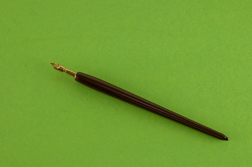 wooden pencil and pen on a black cloth background