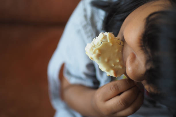 Little girl with blonde hair eats ice cream
