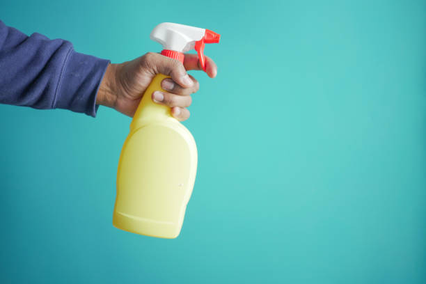 istock holding a plastic bottle spraying disinfect with copy space 1943029635