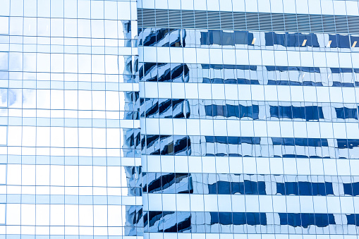 Reflection of office building on glass wall, abstract background with copy space, full frame horizontal composition