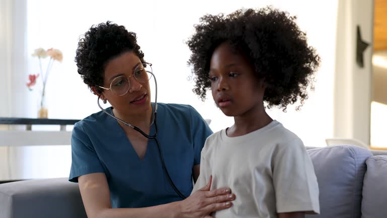 Doctor performing a medical exam on a sick African American girl at home