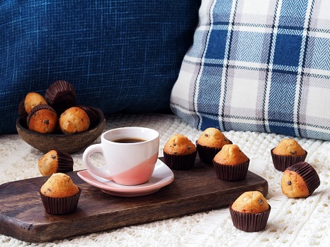 Cozy Coffee Scene: Muffins and Coffee on Sofa