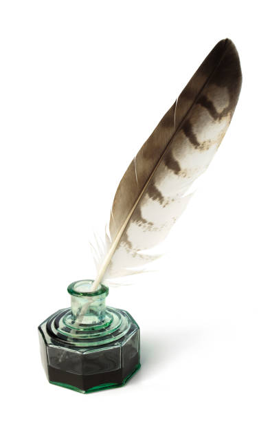 istock Feather and ink bottle on white background. Calligraphy, old education, vintage handwriting 1943088475
