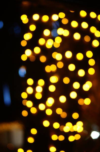 istock Blurred abstract background with spot decorative lights yellow color 1943103444