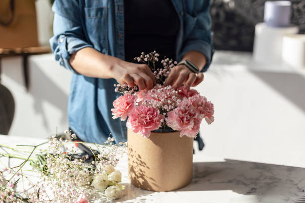 istock Female hands working with flowers 1943109868