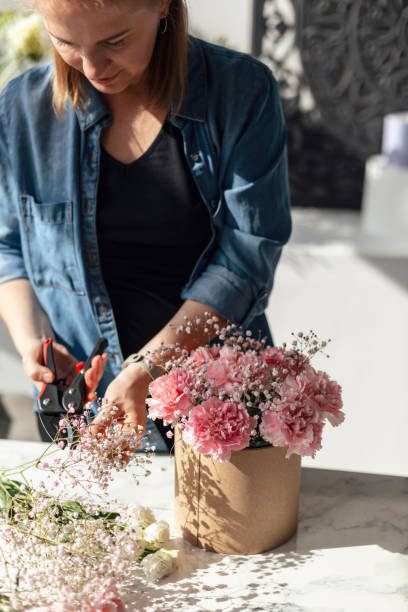 istock Female hands working with flowers 1943109878