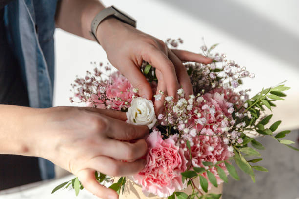 istock Female hands working with flowers 1943110417