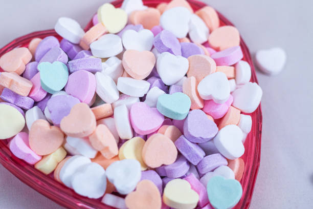 istock Heart Shaped Sugar Candies in a a Red Heart Shaped Dish 1943126345