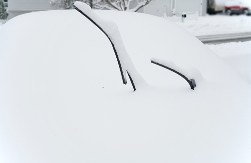 close up on snow covered car parked on the driveway
