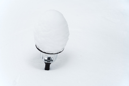 snow covered on path light after storm