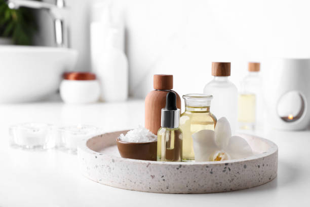 istock Essential oils, sea salt and orchid flower on white table in bathroom. Space for text 1943136357