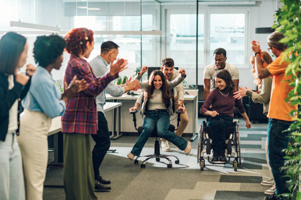 istock Multiracial business team having fun while racing on office chairs 1943136621
