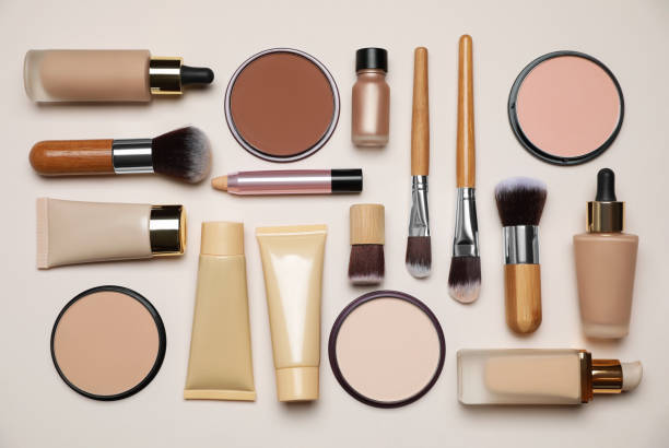 istock Face powders and other makeup products on beige background, flat lay 1943147282
