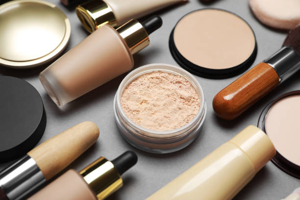istock Face powders and other makeup products on grey background, closeup 1943149939
