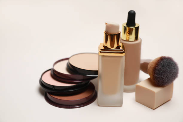 istock Face powders, foundations and makeup brush on light background, closeup 1943150980