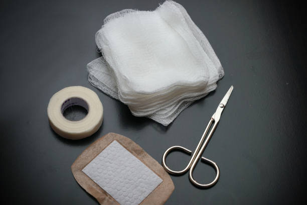 The Gauze pads bandage and scissors used to control bleeding for first aid