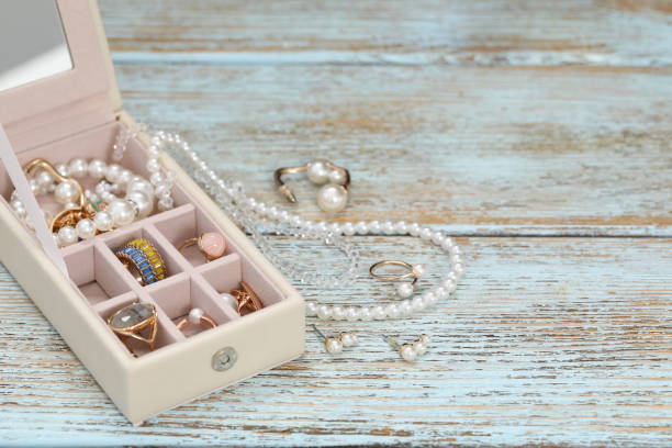 istock Jewelry box with many different accessories on rustic wooden table. Space for text 1943169366