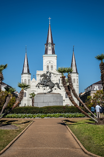 New Orleans, LA - October 18, 2023: Entrance to Jackson Square from Decatur Street with the statue of Andrew Jackson on a horse  and the St. Louis Cathedral in the background.