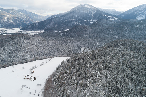 Winter mountain landscape with forests covered with snow, aerial view, Swiss Alps.