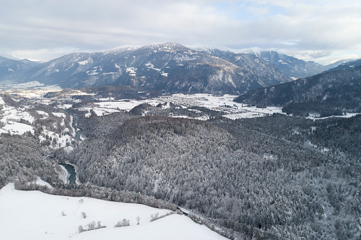 Winter mountain landscape with forests covered with snow, Swiss Alps, aerial view.