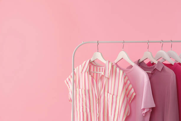 istock Rack with different stylish women's clothes on pink background. Space for text 1943200667