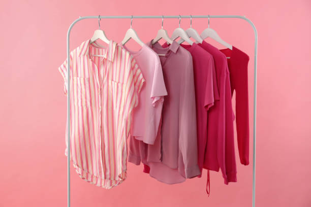 istock Rack with different stylish women's clothes on pink background 1943201192