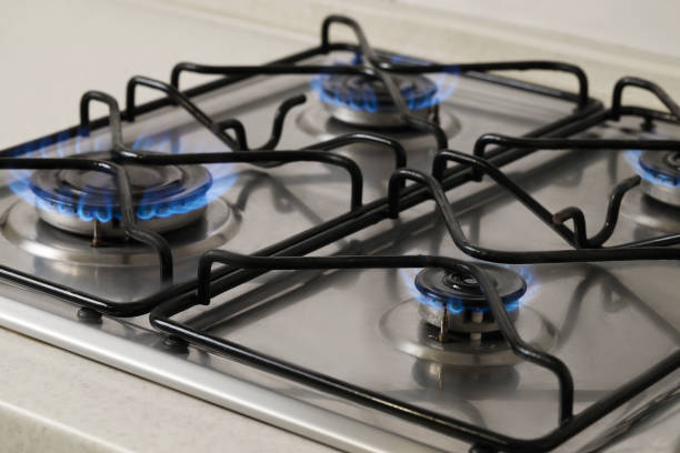 istock Gas cooktop with burning blue flames, closeup 1943217809