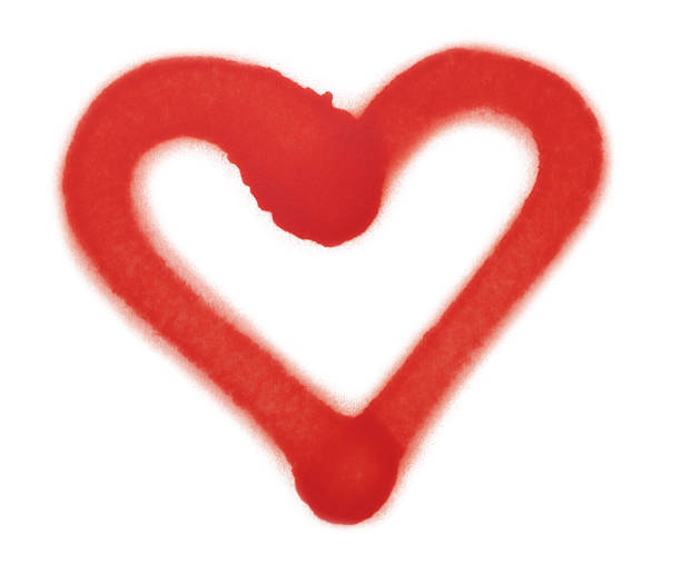 Heart drawn by red spray paint on white background