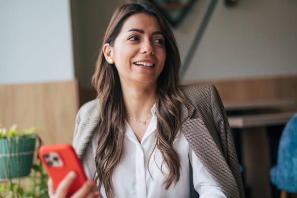 istock Beautiful young woman texting on smartphone in cafe and drinking coffee 1943220431