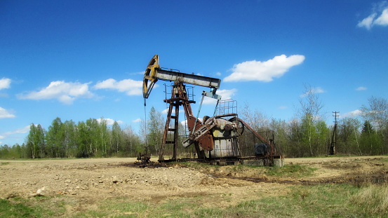 One pump jack producing oil, Image taken near the town of Virden, Manitoba. Image taken from a tripod.