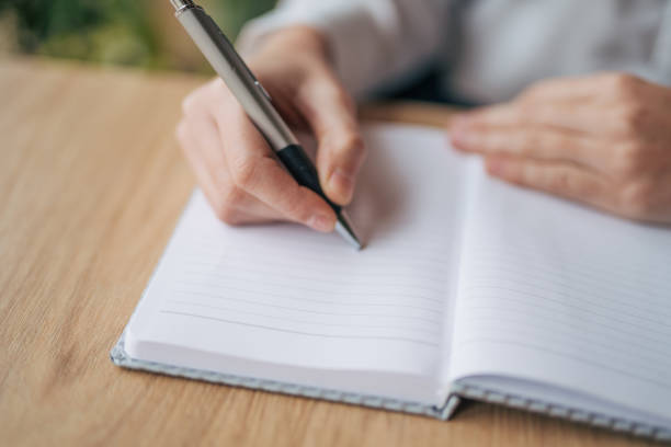 istock Young woman writing notes in the cafe 1943249002