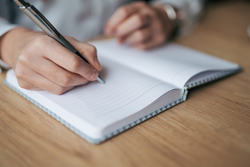 Young woman writing notes in the cafe