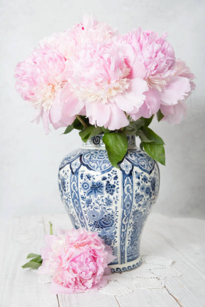 istock pink luxurious peonies in an ancient Chinese vase with blue ornament, springtime 1943253298