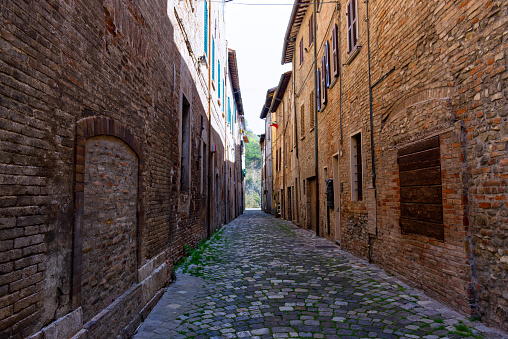 Vertical perspective of narrow medieval cobbled street in middle Italy. HQ photo