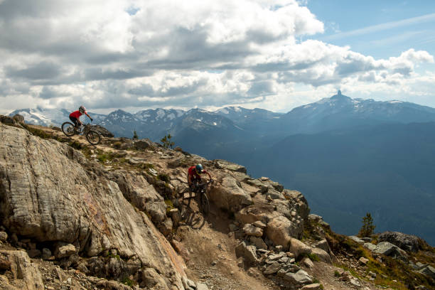 istock Friends ride mountain bikes down rocky trail 1943273186