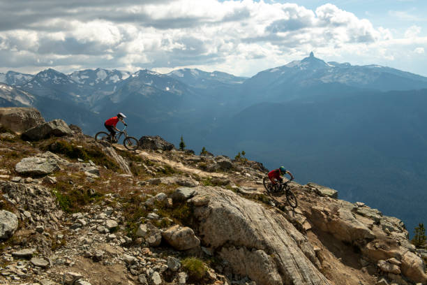 istock Friends ride mountain bikes down rocky trail 1943273710