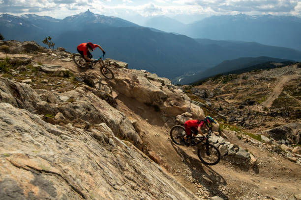 istock Friends ride mountain bikes down rocky trail 1943274730