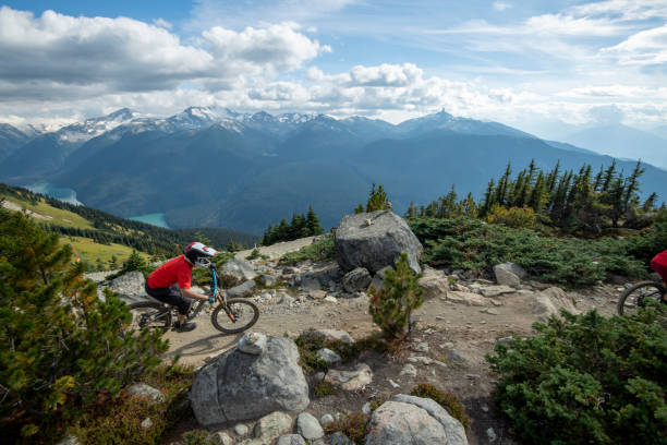 istock Mountain biker rides down rocky trail from mountain 1943276288