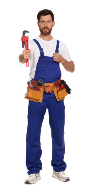 istock Professional plumber with pipe wrench and tool belt on white background 1943278383