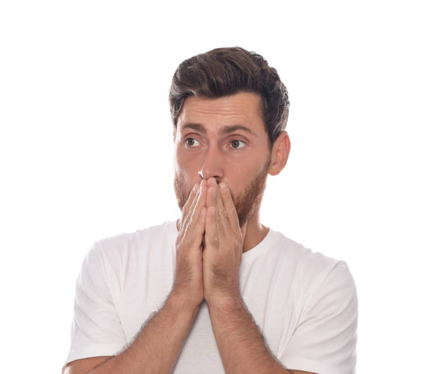istock Embarrassed man covering face with hands on white background 1943279991