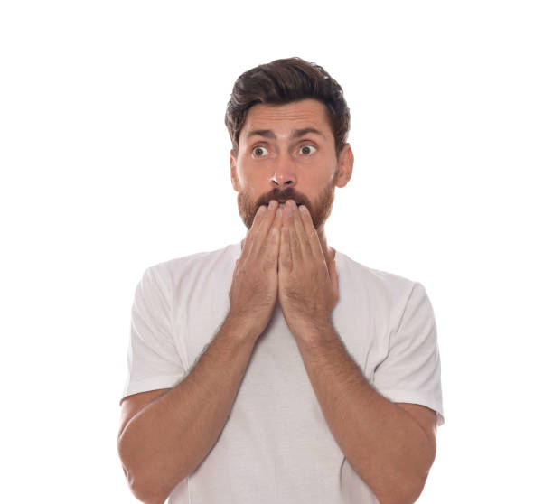 istock Embarrassed man covering face with hands on white background 1943279992