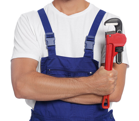 Professional plumber with pipe wrench and on white background, closeup