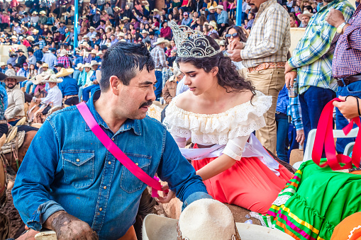 Monte Escobedo, Zacatecas Mexico, September 12 2022 beautiful woman and young queen rewarding a rider man at a saints day  in laguna grande monte escobedo zacatecas