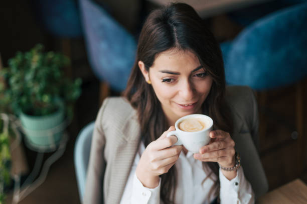 istock A woman enjoys a cappuccino in a cafe 1943313905