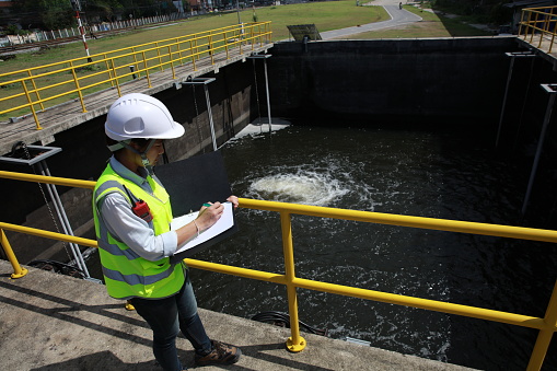 Inspector walking on wastewater pond in a water treatment plant